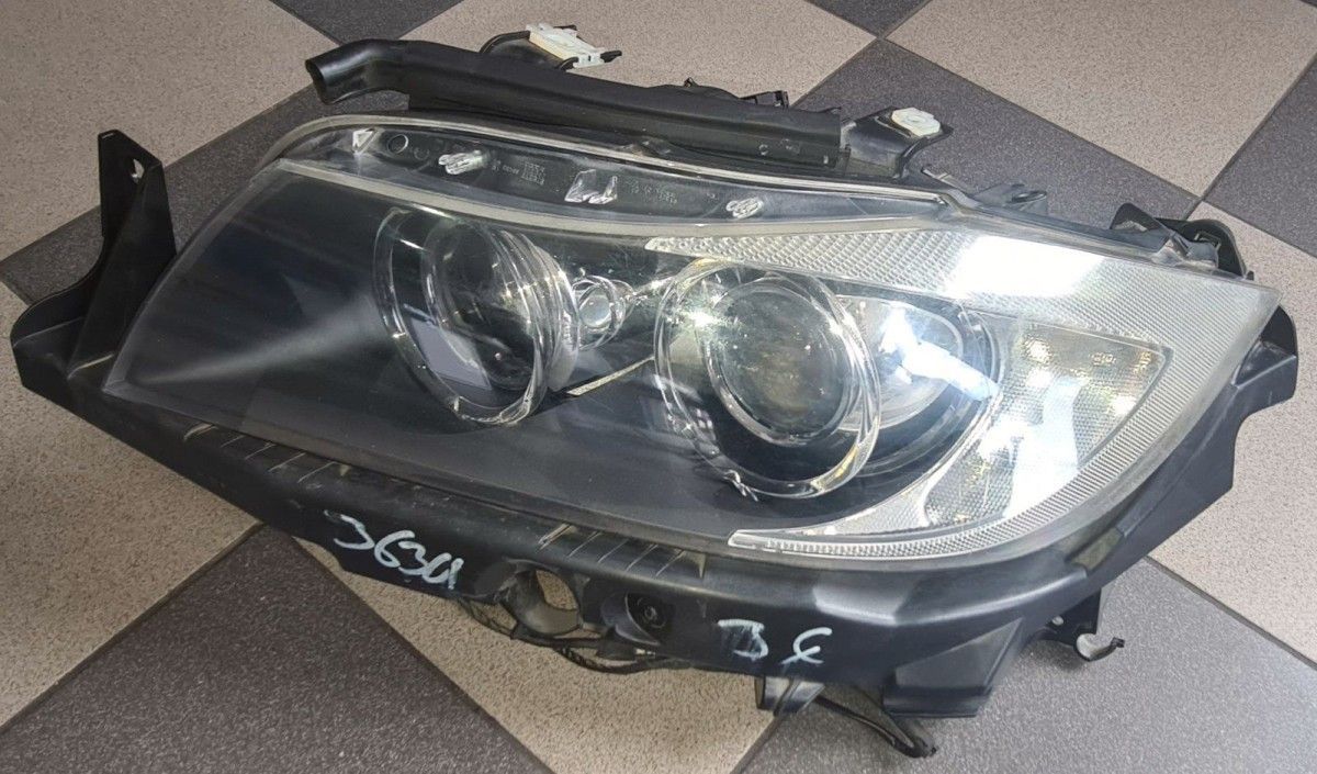 BMW original E90 headlight with cornering light on the left